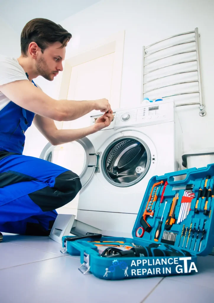 Professional technician inspecting washing machine drum bearings in North York.