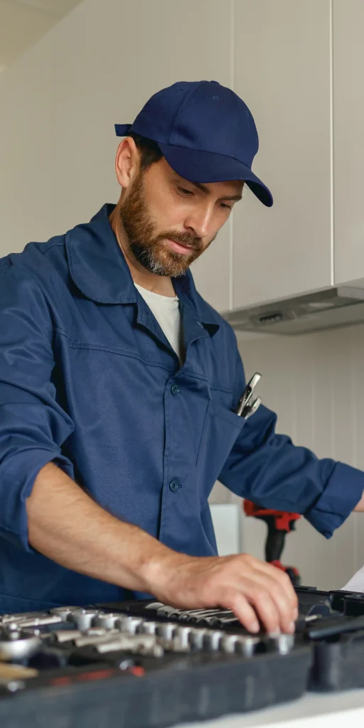 Experienced appliance repair technician working with tools in Toronto home kitchen
