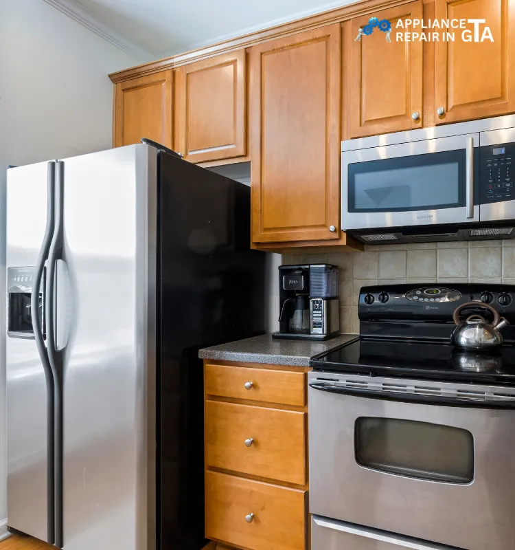 Modern kitchen with stainless steel fridge, stove, and microwave for appliance repair in Scarborough.