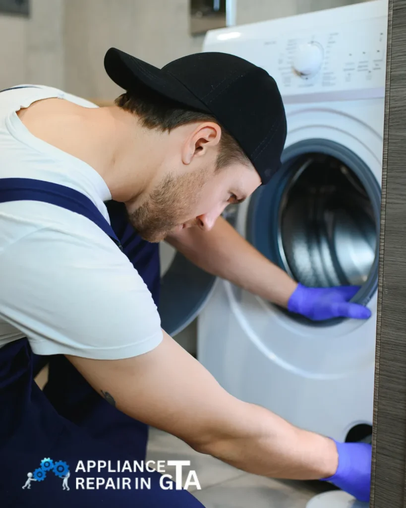 Appliance repair specialist fixing a washing machine in Vaughan—washer repair and laundry appliance services.