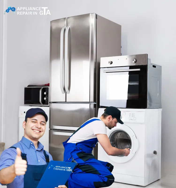 Technician repairing a washing machine beside a stainless steel fridge and oven in Scarborough.